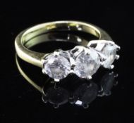 An 18ct gold and three stone diamond ring, the stones with an approximate total weight in excess