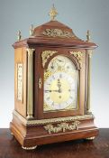 An Edwardian ormolu mounted mahogany chiming mantel clock, with architectural case and arched