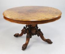 A Victorian burr walnut circular breakfast table, the heavy carved base with central vase shaped