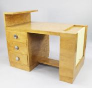 An unusual Art Deco burr maple writing desk, the top with a raised single end shelf above three