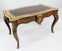 A Victorian style ebonised and ormolu mounted two drawer writing table, with brass and simulated