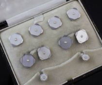 A 1920's 9ct white gold, mother of pearl and split pearl set eight piece dress stud set, in Z.