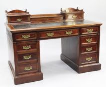 A Victorian mahogany pedestal desk, the low superstructure with two drawers and central hinged lid