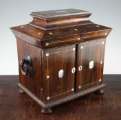 A Victorian rosewood and mother of pearl inlaid table top cabinet, the sarcophagus shaped lid