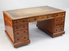 A Victorian mahogany pedestal partner's desk, the top with tooled leather writing surface above an