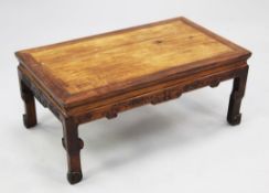 A Chinese huanghuali kang table, 18th/19th century, the rectangular top above a bat and cloud carved