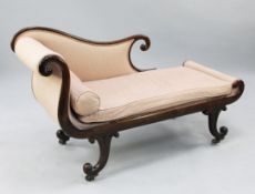 An unusual small early 19th century rosewood chaise longue, with scrolled arms and ends, on carved