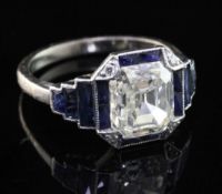 An Art Deco platinum single stone diamond and sapphire octagonal dress ring, with central emerald