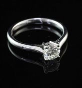 An 18ct white gold and solitaire diamond ring, the round brilliant cut stone weighing