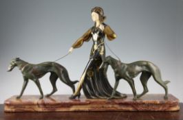A French Art Deco figure group modelled as a stylish woman walking with two Borzoi's, unsigned,