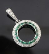 A white gold, emerald and diamond open circular pendant, with emerald and diamond set border and
