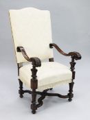A late 17th century style Italian carved walnut open armchair, upholstered in a cream floral damask,
