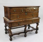 A William & Mary crossbanded walnut chest on stand, with two short and two long drawers, with