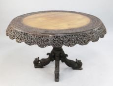 A large Anglo Indian carved padouk circular centre table, with top border and pierced shaped frieze,