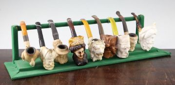 A collection of Meerschaum pipes and cheroot holders, including an example carved as a female nude