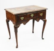 A Queen Anne yew wood lowboy, fitted with three frieze drawers above a shaped apron, on slender
