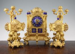 A 19th century French Henri II style three piece ormolu and porcelain clock garniture, comprising