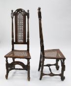A pair of 17th century walnut and beech chairs, the tall backs with scroll arched crest above part