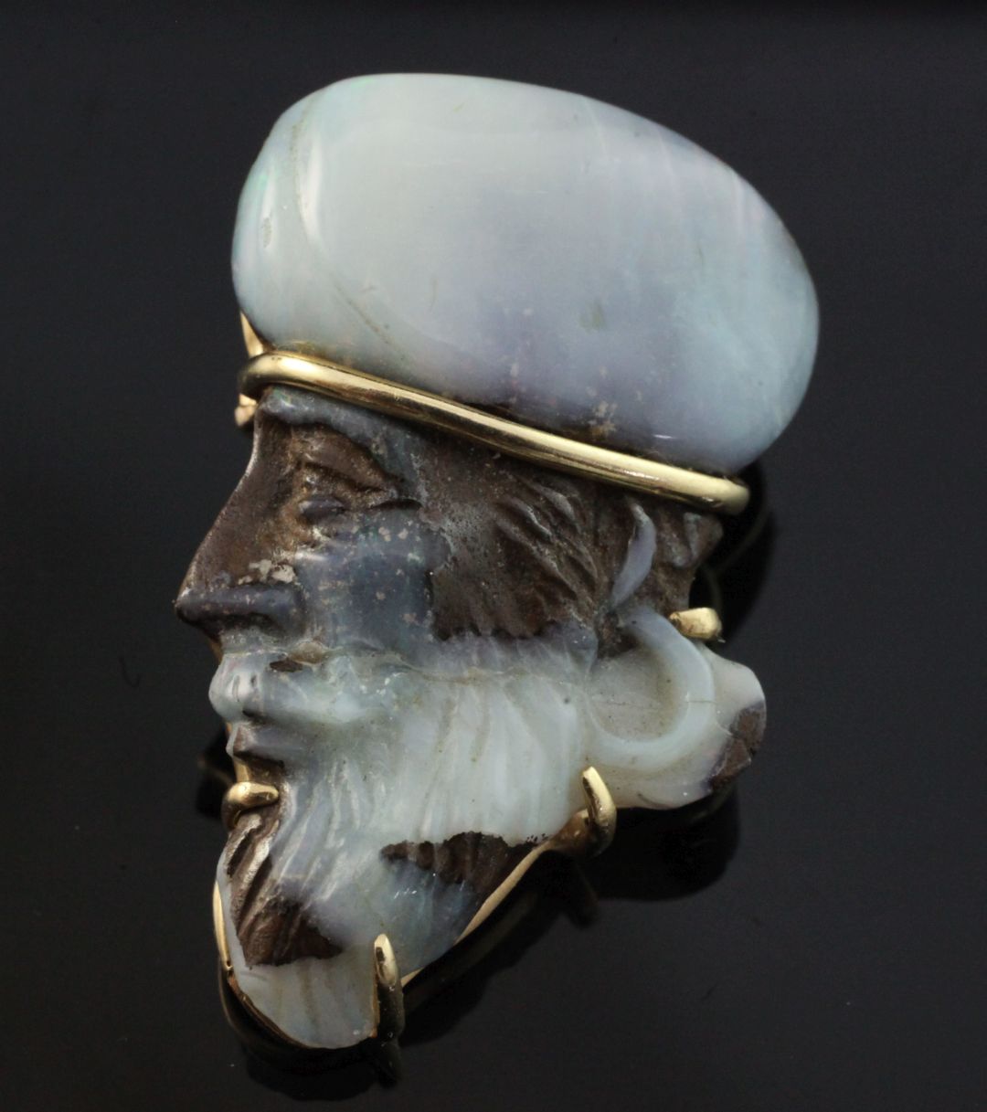 A 20th century gold mounted white opal pendant brooch modelled as the head of a Middle Eastern