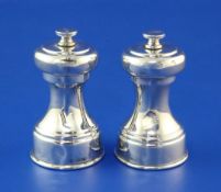 A pair of 1930's silver pepper mills by William Hutton & Sons Ltd, of waisted form, Sheffield, 1936,