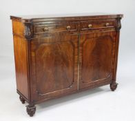 An early 19th century mahogany side cabinet, fitted with two frieze drawers above two cupboard doors