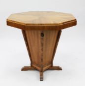 An Art Deco octagonal walnut centre table, with central tapering square section column and cruciform