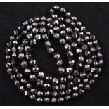 A 1920's/1930's single strand graduated facetted garnet bead necklace, 24in