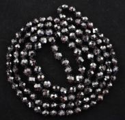 A 1920's/1930's single strand graduated facetted garnet bead necklace, 24in