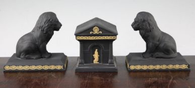 A pair of Wedgwood black basalt lion figures and a similar temple form inkwell cover, modern, each