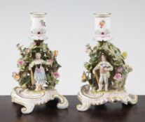 A pair of Meissen arbour chambersticks, early 20th century, each modelled with the figure of a boy