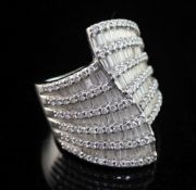 A stylish modern 18ct white gold and diamond encrusted dress ring, set with round brilliant and