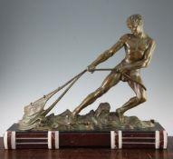 Attributed to Ouline. A French Art Deco patinated metal model of a male fisherman hauling his catch,