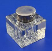 An Edwardian silver mounted glass combination inkwell/ pocket watch holder, of square form with