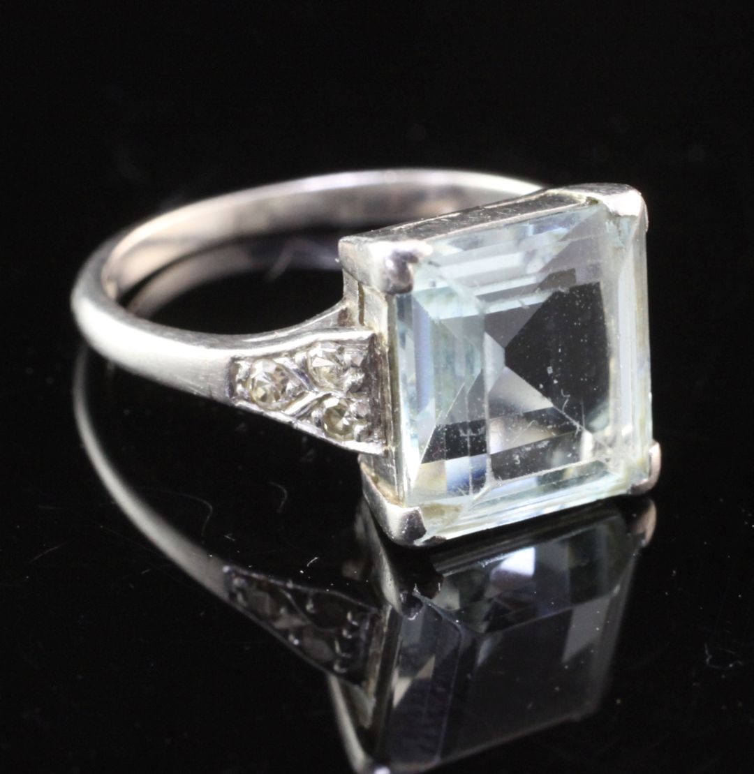 A mid 20th century platinum, aquamarine and diamond ring, with emerald cut aquamarine and diamond