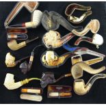 A collection of meerschaum pipes and cheroot holders including LeNouvel jester's head and eagle