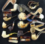 A collection of meerschaum pipes and cheroot holders including LeNouvel jester's head and eagle