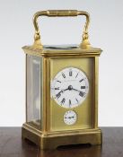 A 19th century gilt brass carriage alarum clock, with enamel dials and movement striking on a