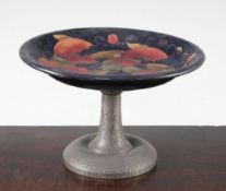 A William Moorcroft pomegranate pattern Tudric pewter mounted comport, c.1920, the dish top with