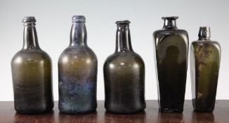 Five dark green glass bottles, late 18th / early 19th century, two of square tapering form, 20.5cm