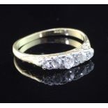 A 18ct gold and graduated five stone diamond ring, size M.