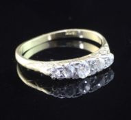 A 18ct gold and graduated five stone diamond ring, size M.