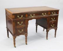 A late Victorian mahogany desk, the top with gilt tooled brown leather inset writing surface above