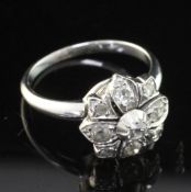 An early 20th century white gold and diamond cluster ring, of flower head design, set with old and