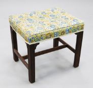A George III mahogany rectangular foot stool, with floral upholstered seat, on moulded square