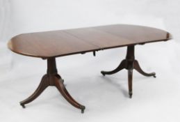 A Regency mahogany D end dining table with leaf, on ring turned columns and downswept legs.