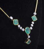 An attractive 18ct gold, emerald and diamond drop necklace, set with four emeralds, including