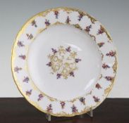 A Sevres porcelain plate, late 18th century, decorated with scattered flowers, with interlaced L'