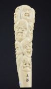 A Japanese ivory cane or parasol handle, early 20th century, carved in high relief with seventeen