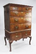 An early 18th century walnut and oak chest on stand with two short and three long drawers over two