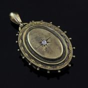 A Victorian 15ct gold and diamond set oval pendant locket, with beaded border and central star